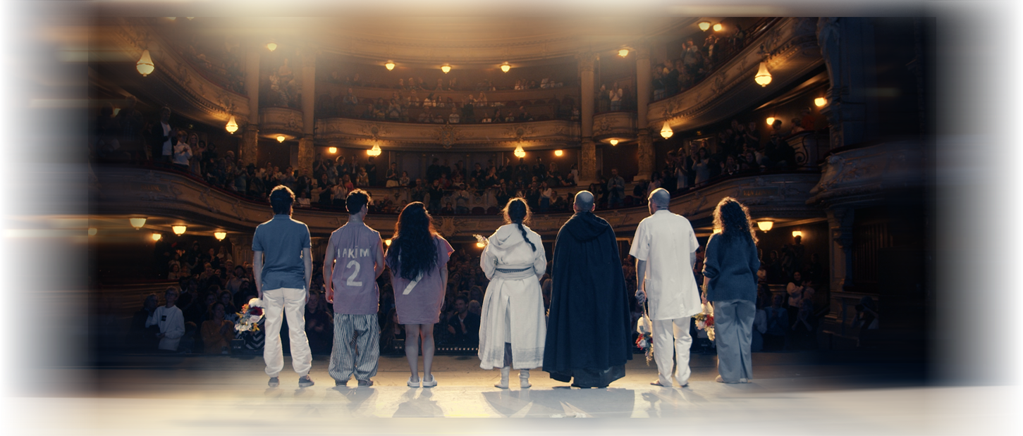 Actors on stage looking at audience